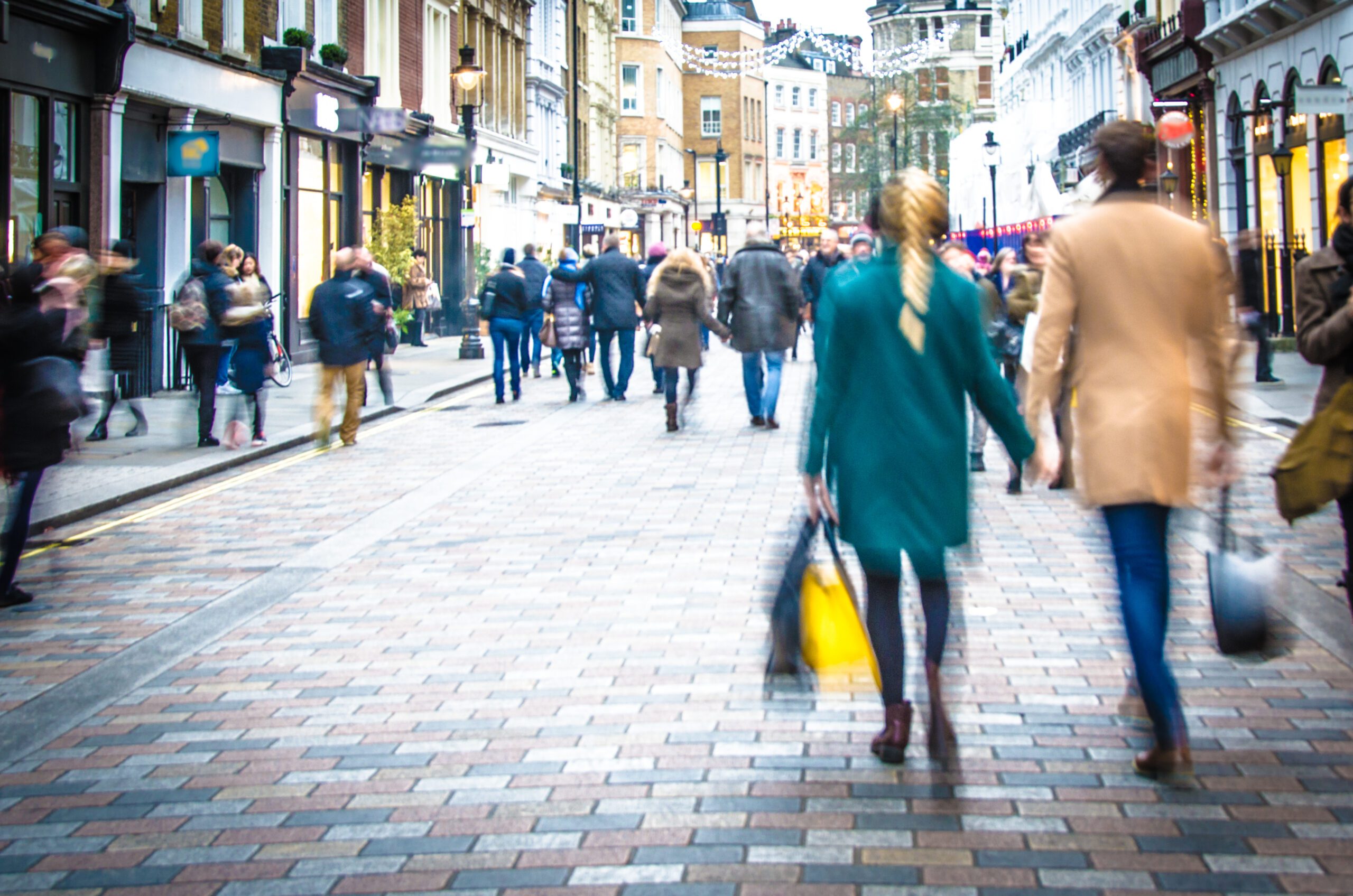 Shoppers,Holding,Hands,In,Busy,London,High,Street