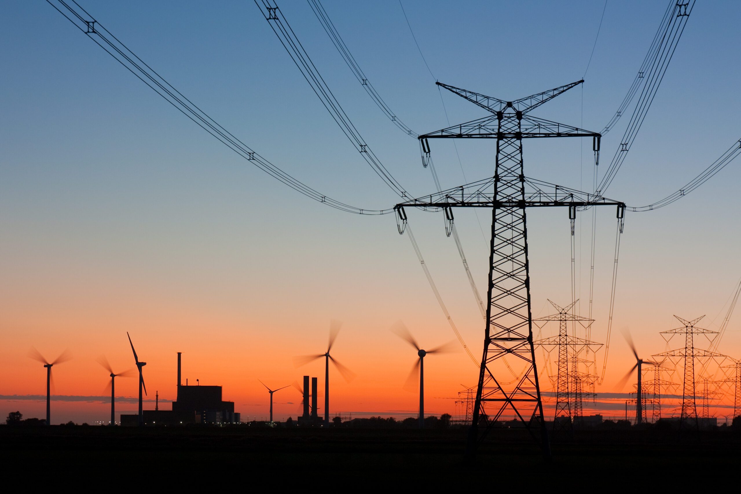 High,Voltage,Power,Lines,With,Electricity,Pylons,At,Twilight