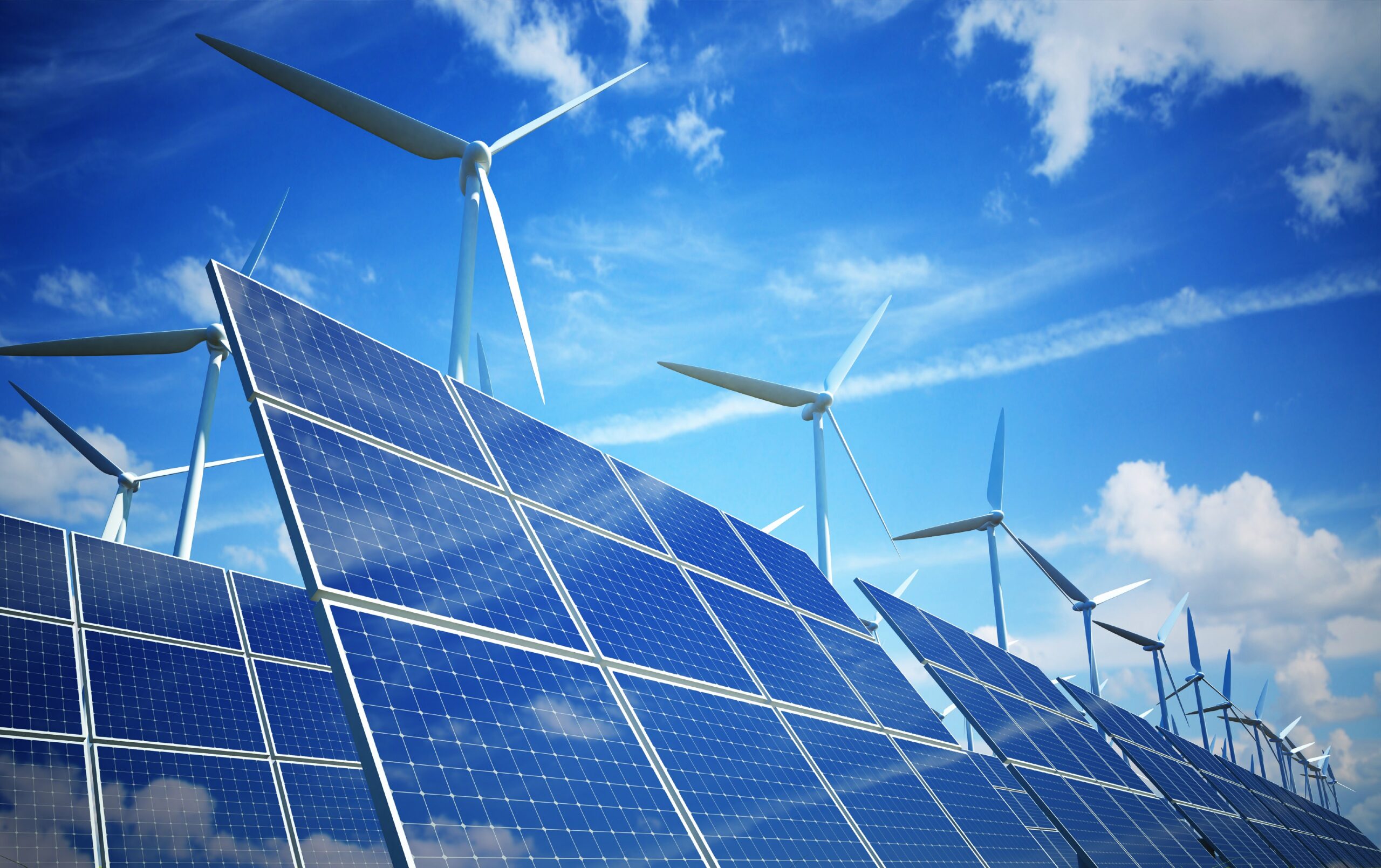 Solar panels, wind turbines, clouds and blue sky