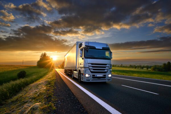 Truck,Driving,On,The,Asphalt,Road,In,Rural,Landscape