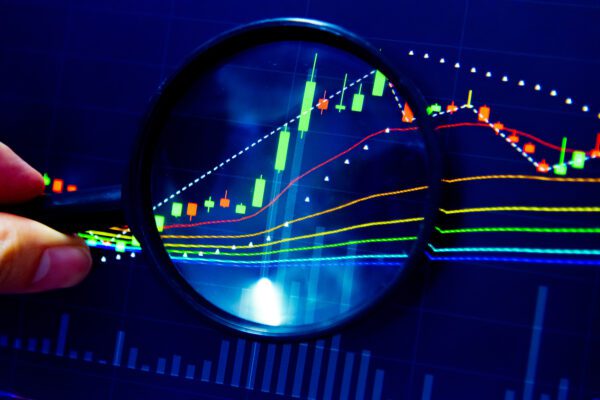 Magnifying glass examining a graph.