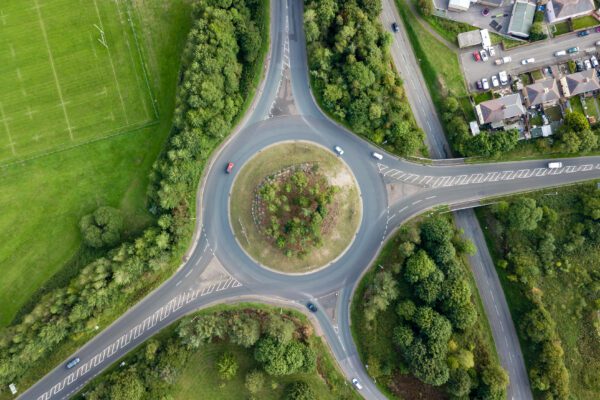 Transport - aerial view of a roundabout in the countryside with cars passing