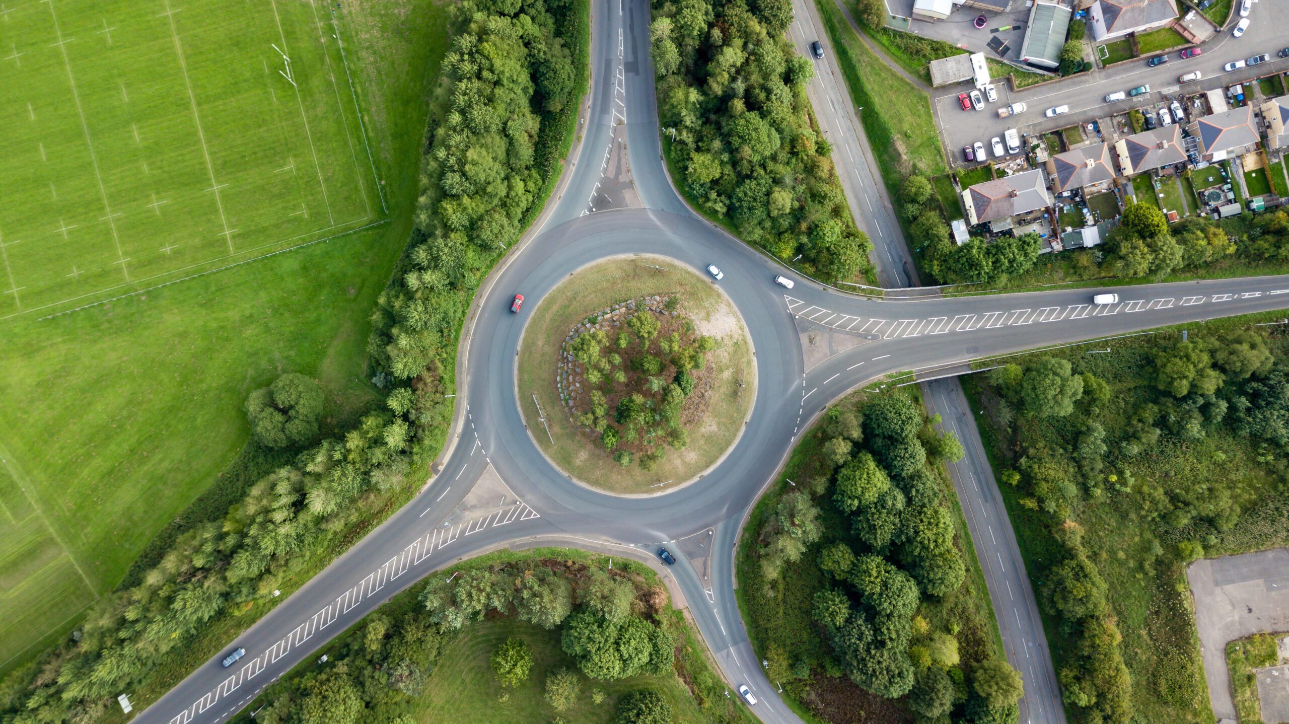Transport - aerial view of a roundabout in the countryside with cars passing
