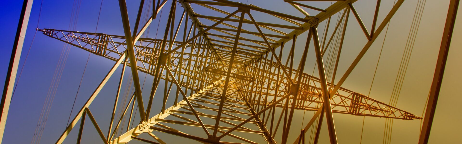 Underneath a pylon with sunset in background