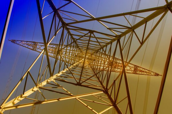 Underneath a pylon with sunset in background