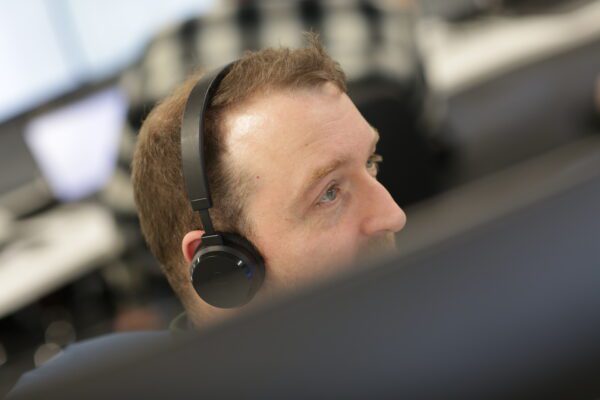 Image for Worker with headset looks off camera
