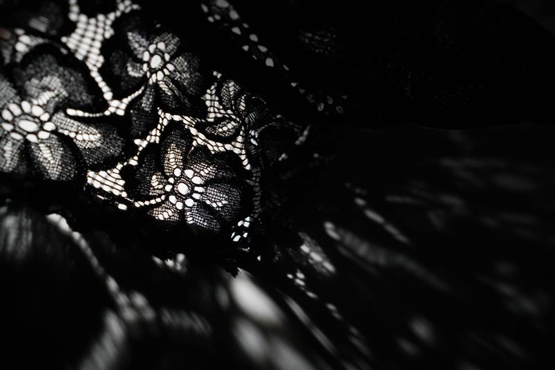 Lace against black background. Source: AdobeStock