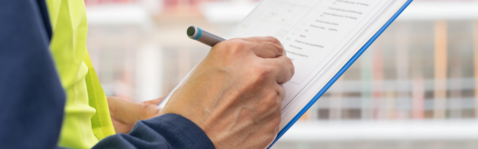 Hands, engineer and clipboard in city for checklist, inspection notes or safety compliance. Person, writing with documents for urban development, project management or supervisor paperwork and pen